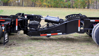 The optional Nitro-Stinger (a type of booster axle assembly) not only satisfies the spread axle permit requirements of many states but provides constant weight distribution to the rear axles.  A knuckle assembly in the booster frame assists in the trailer's maneuverability while moving forward.  The knuckle can be locked in place and the rear axles raised hydraulically to assist in moving the trailer in reverse.