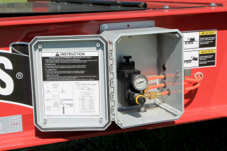 A box mounted to the side of the drawbar contains the air controls for the front axle.
A load scale chart allows the operator to set the air pressure on the front axle to carry the desired weight.