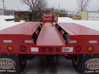 Customer specified depressed center plate protects from road spray and is reinforced so a track-style milling machine can be placed on the rear frame.