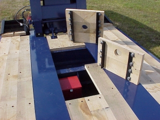 Wood-covered toolboxes provide storage in the deck for chains and blocks.

This space also has stores the battery for the self-powered auxiliary light system.