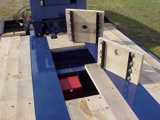 Wood-covered toolboxes provide storage in the deck for chains and blocks.

This space also has stores the battery for the self-powered auxiliary light system.