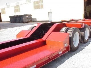 Modified bridge ramps allow a machine to load over the rear frame.

Bearings for removable side brackets are installed to accomodate special sized brackets.