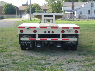 The rear impact guard is welded tot he rear channel below the extension.

The square opening on top of the rear deck is for access to the mechanical height control of the air ride suspension.