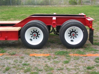 This view of the rear frame shows the oak decking to the tires, and the narrow outriggers bewteen the steel disc wheels.
