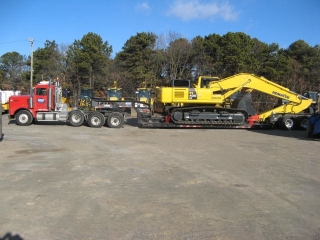 This 105-ton capacity ROGERS® trailer easily hauls a drill rig, a crawler excavator and other oversized/overweight equipment while maintaining the 13'6" overhead clearance required for crossing bridges in the New York City area.  The wheels of this loader rest in wheel wells, which saves four inches of overhead clearance.