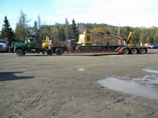 ROGERS® 55-ton Ultima trailer, custom-built for Guptill Logging, is seen here hauling a feller-buncher.