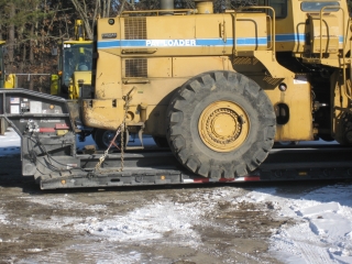 This 105-ton capacity ROGERS® trailer easily hauls a drill rig, a crawler excavator and other oversized/overweight equipment while maintaining the 13'6" overhead clearance required for crossing bridges in the New York City area.  The wheels of this loader rest in wheel wells, which saves four inches of overhead clearance.