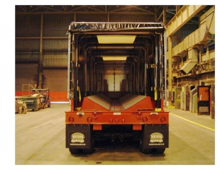 Rogers® 65-ton capacity trailer hauls steel coils between different processing areas of a steel mill during three shifts, seven days a week.  Equipped with interchangeable heat-resistant trays and a tarp, the trailer can haul different size coils during all kinds of weather.
