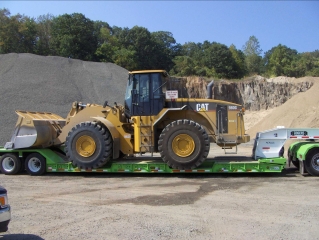 The same Rogers® 55-ton trailer hauls a Cat rubber-tire loader and a Grove rough terrain crane, plus many other pieces of heavy equipment for Stone Industries.