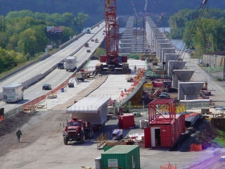 Twin bridges being constructed over the Susquehanna River at Harrisburg, PA.  ROGERS® 100-ton capacity Specialized trailer built to haul precast bridge segments.